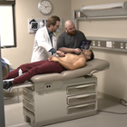 New ultrasound technology is used for training on KCU student laying on examination table. 